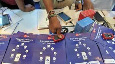 An Indian visitor gives a thumb impression to withdraw money from a Jio Easy Money outlet with his Unique Identification card. India's digital sector is accelerating faster than ever as Covid-19 forces businesses and customers online. AFP