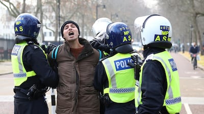 Police officers detain an anti-lockdown protestor during a demonstration amid the coronavirus disease (COVID-19) outbreak in London. Reuters