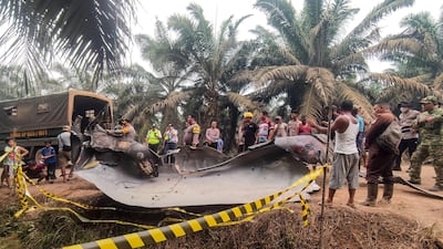 A large charred metallic fragment, suspected to be rocket debris, which fell on an oil palm plantation in Indonesia's Central Kalimantan province. AFP