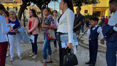 A US embassy official checks the documents of Cubans before entering the embassy in Havana. AFP