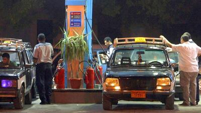 Taxi drivers fill up their vehicles at a gas station in Cairo. Amr Dalsh / Reuters