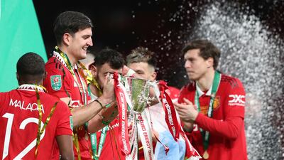 Manchester United's Harry Maguire holds the trophy. AP