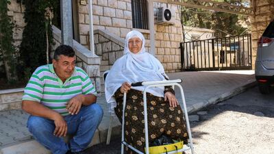 An elderly Syrian refugee waits at the Lebanon-Syria border before her evacuation back to Syria. AFP