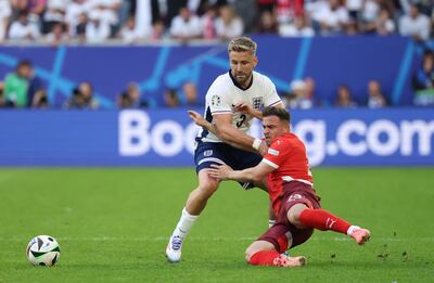 Luke Shaw of England, left, tussles with Xherdan Shaqiri of Switzerland. EPA