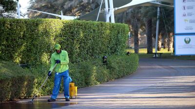 A cleaner from Lava Jet works near the Corniche beach area in Abu Dhabi. Ravindranath K / The National