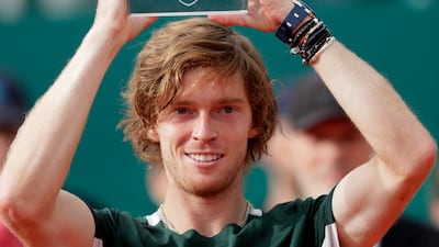 Andrey Rublev poses with the trophy. AFP