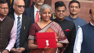 Indian Finance Minister Nirmala Sitharaman (centre) holds a folder containing Union Budget documents outside the Ministry of Finance in New Delhi, on Tuesday before the budget's presentation in Parliament. EPA