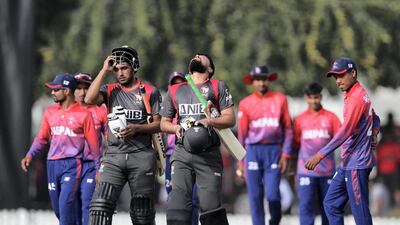 Amir Hayat and Imran Haider of the UAE walk off after winning the game. Chris Whiteoak/The National