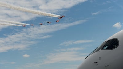 The British Royal Air Force's Red Arrows aerobatic demonstration team perform a flypast. Bloomberg