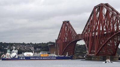 The tanker reverses under the Forth Bridge as it travels to dock at Grangemouth. Russell Cheyne / Reuters