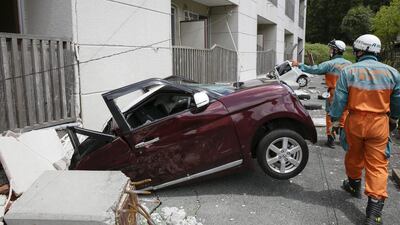 Members of the metropolitan police department special rescue team search for missing people at a flat in Minami-Aso. Kimimasa Mayama / EPA