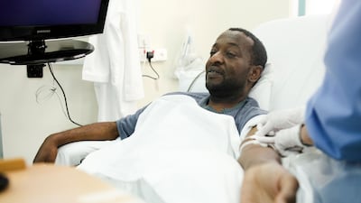 A nurse checks a kidney patient's arm following a dialysis session at Sheikh Khalifa Medical City in Abu Dhabi. Photo: The National