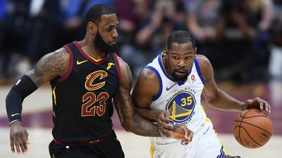 Golden State Warriors forward Kevin Durant drives against Cleveland Cavaliers forward LeBron James. Ken Blaze / Reuters