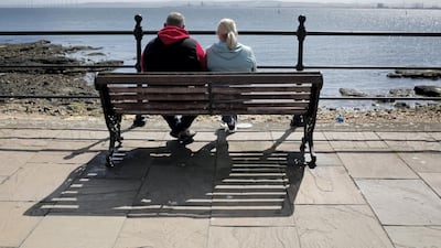 A couple look out from the sea front on Hartlepool's Headland towards Teesport. Stuart Boulton for The National