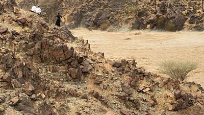 A search and rescue helicopter hovers over a flooded wadi near the village of Wadi Al Helo on the east coast. Courtesy: Sharjah Police