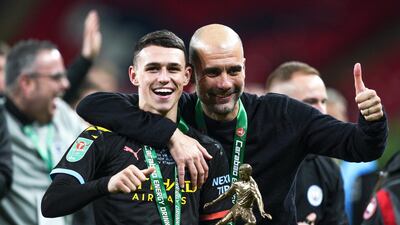 Phil Foden, left, with Manchester City manager Pep Guardiola after being named man of the match in the League Cup final win over Aston Villa at Wembley Stadium in March. EPA