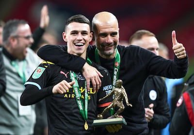 Phil Foden celebrates with manager Pep Guardiola after being named man of the match in the League Cup final against Aston Villa in 2020.