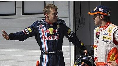Red Bull's Sebastien Vettel of Germany, left, and Renault's Fernando Alonso wonder who grabbed pole as the scoring system went down towards the end of qualifying in Budapest. Alonso was eventually confirmed on pole.