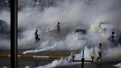 Protesters against the demolition of Gezi Park in Istanbul flee tear gas, May 2013. Ed Ou / Getty Images.