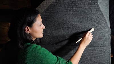 Senior conservator Stephanie Vasiliou prepares the Rosetta Stone before it is moved to a special exhibition in the British Museum to celebrate 200 years since it helped to decode hieroglyphs. PA