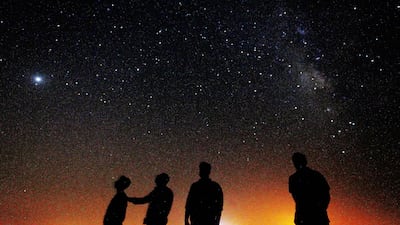People look at the Milky Way galaxy rising in the night sky in Kuwait's Al Salmi desert, 120Km north of the capital.