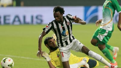 Jonathan Pitroipa, No 11, of Al Jazira tangles with Emirates goalkeeper Abdualla Moosa Ali during their Arabian Gulf League match at Mohamed bin Zayed Stadium in Abu Dhabi on September 25, 2014. Ravindranath K / The National