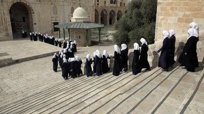 Palestinian schoolgirls walk in line at Al Aqsa Mosque in Jerusalem’s Old City. Ahmad Gharabli / AFP Photo
