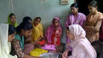 Ruksar Bano reads out a Hindi newspaper to UAE resident Shazia Kidwai, (seated on the right), who runs a literacy program in her home state of Uttar Pradesh in India aimed at helping young girls. Courtesy Shazia Kidwai