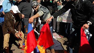Lebanese and Syrian protesters burn Chinese and Russian flags in front of the Russian embassy in Beirut in protest of the countries veto to a UN resolution to end a 11-month crackdown on protests by the Assad regime.