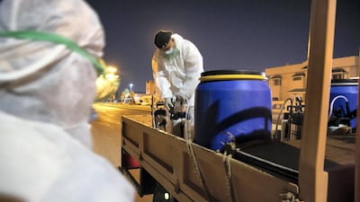 Sharjah Municipal staff prepare to spray and disinfect the sidewalk along the Al Muntazah Street area.