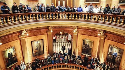 Protesters fill the rotunda of the Michigan State Capitol in Lansing before its state electoral college met to vote unanimously for US president-elect Donald Trump. Sarah Rice / Getty Images / AFP