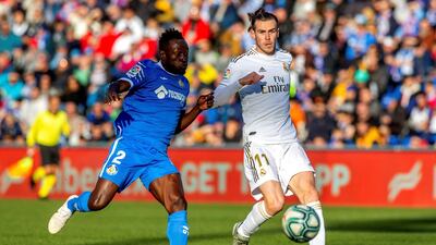 Getafe's defender Dakonem Djene, left, vies for the ball with Real Madrid's Gareth Bale. EPA