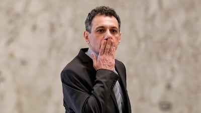 Mr. Zakka blows a kiss to journalists at the presidential palace. AFP