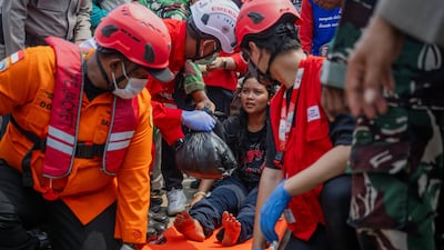 A passenger injured when the Virgo Transport 8 ferry capsized in the Java Sea sits on a stretcher at Trisakti port in Banjarmasin, Indonesia. Reuters