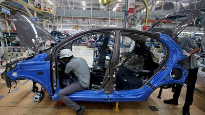 Workers assemble a Tata Tiago car inside the Tata Motors car plant in Sanand, on the outskirts of Ahmedabad, India, August 7, 2018. REUTERS/Amit Dave/File Photo