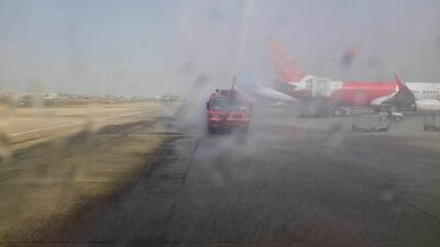Ground staff spray the new Rotana Jet's inaugural flight after landing in Dubai International Airport.