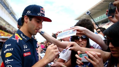 Daniel Ricciardo signs autographs for fans in the pit lane ahead of the Spanish Grand Prix. Clive Mason / Getty