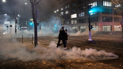 Tear gas was used to disperse crowds in Paris. AP