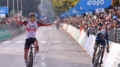 Tadej Pogacar of UAE Team Emirates celebrates as he crosses the finish line to win the 116th edition of the Giro di Lombardia. EPA