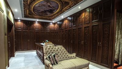 A walk-in closet keeps up the vintage opulence theme.