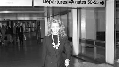Kylie Minogue, in a black blazer, walks through Heathrow Airport ahead of the Royal Variety Show in London, England, on November 21, 1988. All photos: Getty Images