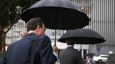 Office-goers had to bring out the umbrellas on Tuesday. Delores Johnson / The National