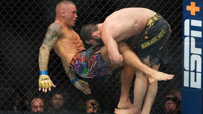 Islam Makhachev takes down Dustin Poirier during the second round of their lightweight title bout at UFC 302. AP