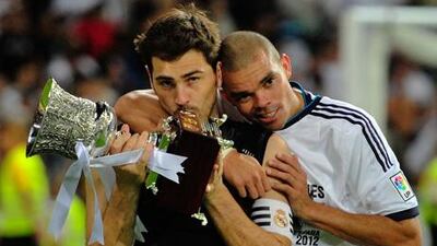 Real Madrid captain Iker Casillas and teammate Pepe celebrate with the Spanish Super Cup