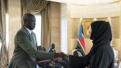 Reem Ibrahim Al Hashimi, UAE Minister of State for International Cooperation (R), exchanges an MOU with a South Sudanese counterpart during an MOU signing ceremony at Al Shati Palace. Mohamed Al Hammadi / Ministry of Presidential Affairs