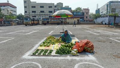 A vegetable vendor sets up her stall on a marked area on the floor maintaining social distancing in Chennai. AFP