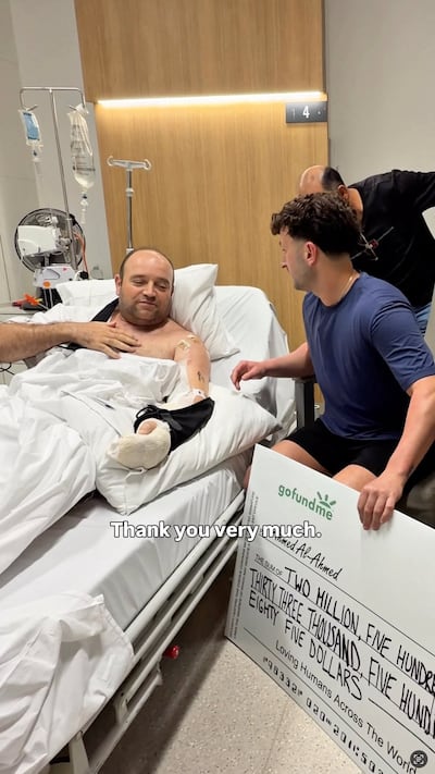 Social media influencer Zachery Dereniowski presents a cheque to Ahmed Al Ahmed at St George Hospital in Sydney. @mdmotivator via TikTok/via Reuters
