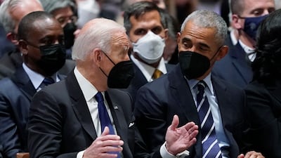 President Joe Biden talks with former president Barack Obama before the service. AP