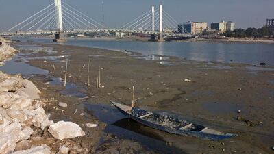 An aerial view shows the Hadarat bridge across the Euphrates river that is witnessing a sharp decrease in water levels, in Nassiriya on February 26, 2023. - Iraq's Tigris and Euphrates rivers have witnessed a sharp decrease in water levels in the south of the country, officials said, pledging to take urgent measures to ease shortages in the parched country. (Photo by Asaad NIAZI / AFP)