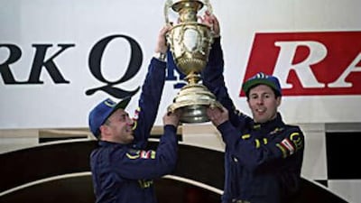 Colin McRae, right, celebrates winning the World Rally Championship after his victory in the Rally of Britain in 1995.